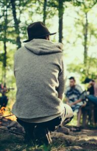 A man enjoys sitting by a fire during drug addiction treatment in Lawrenceville, GA.