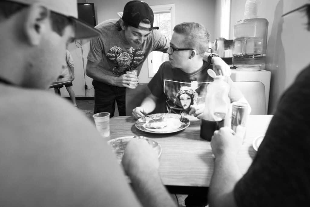 Men sharing a meal during rehab near Alpharetta GA recovery program