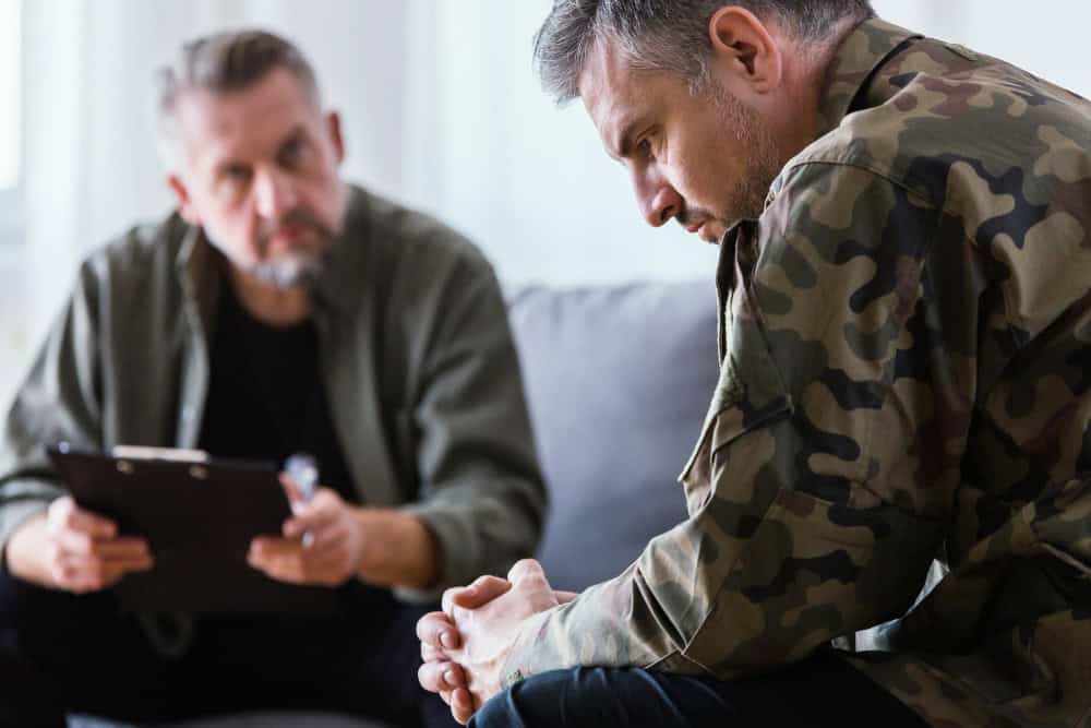 Veteran talking about trauma during rehab for veterans in Georgia counseling session at Purple Recovery