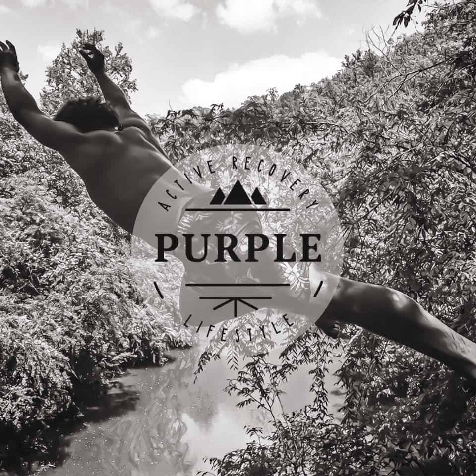 Man jumping into a body of water with the Purple logo displayed.