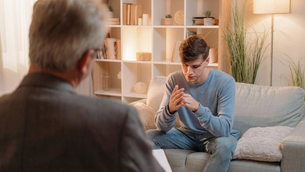 Man talking with a psychiatrist during bipolar disorder treatment in Georgia.