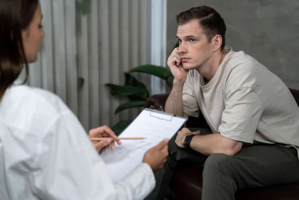 Distressed patient speaking with a psychiatrist during borderline personality disorder treatment in Georgia.