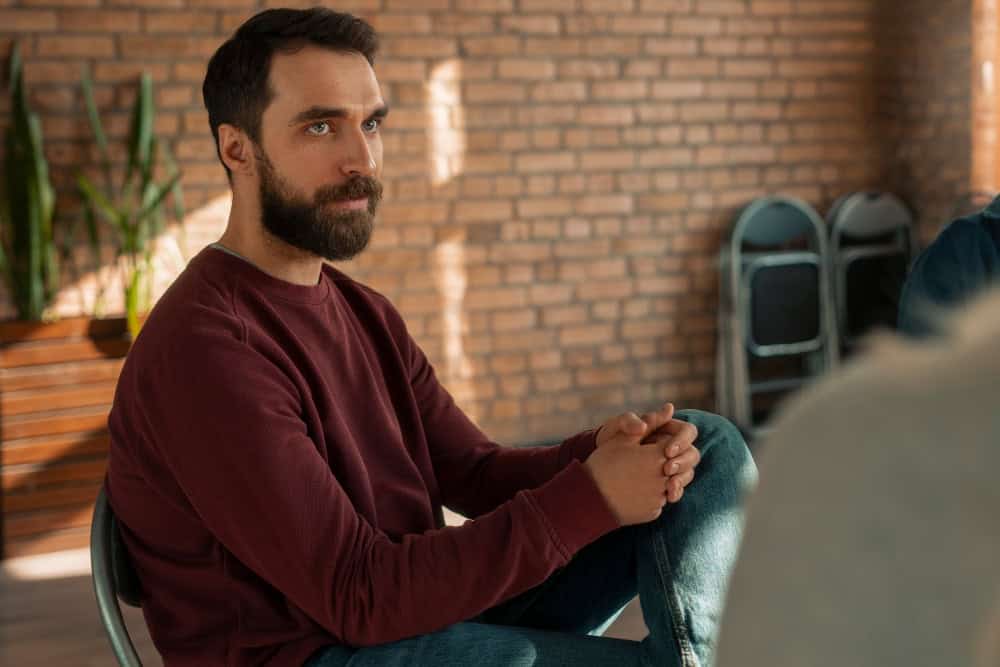 Man participating in a support group during bipolar disorder type 1 treatment in Lawrenceville, GA.