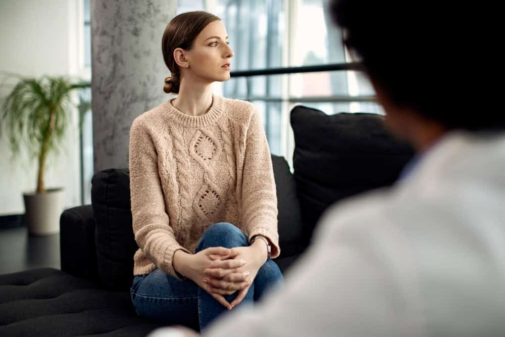 Thoughtful young woman during a psychotherapy session for borderline personality disorder treatment in Lawrenceville, GA.