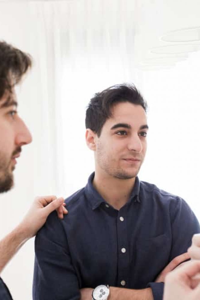 Male colleagues talking during a therapy session at a mental health treatment center in Lawrenceville, GA.
