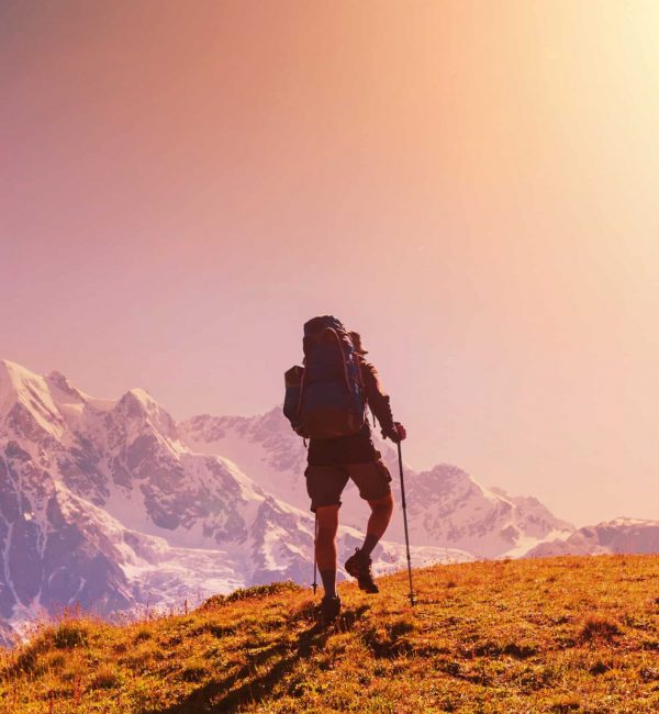 A man hiking up a scenic mountain trail as part of an adventure therapy program at an outpatient rehab in Georgia.